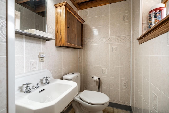 3324 96th St, Sturtevant, WI 53177 - bathroom featuring toilet, tile walls, and a sink