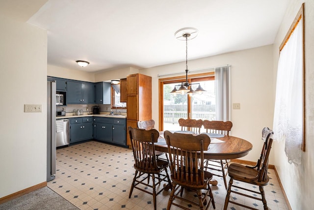 3324 96th St, Sturtevant, WI 53177 - dining area featuring baseboards and a chandelier