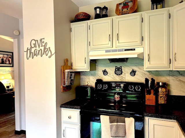2621 Golf Course Rd, Wisconsin Rapids, WI 54494 - kitchen with electric stove, under cabinet range hood, backsplash, and dark countertops