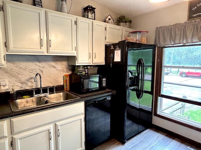 2621 Golf Course Rd, Wisconsin Rapids, WI 54494 - kitchen featuring black appliances, a sink, healthy amount of natural light, tasteful backsplash, and a textured ceiling