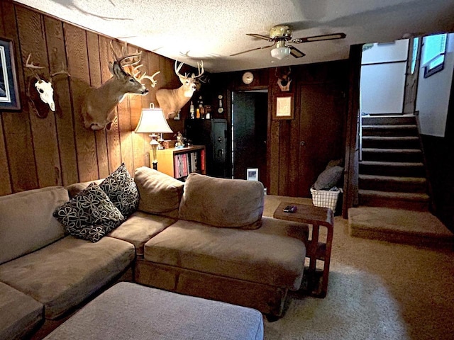 2621 Golf Course Rd, Wisconsin Rapids, WI 54494 - carpeted living room with a ceiling fan, stairs, and wooden walls