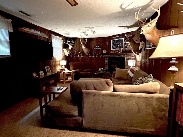 2621 Golf Course Rd, Wisconsin Rapids, WI 54494 - carpeted living room with wooden walls, a brick fireplace, and a textured ceiling