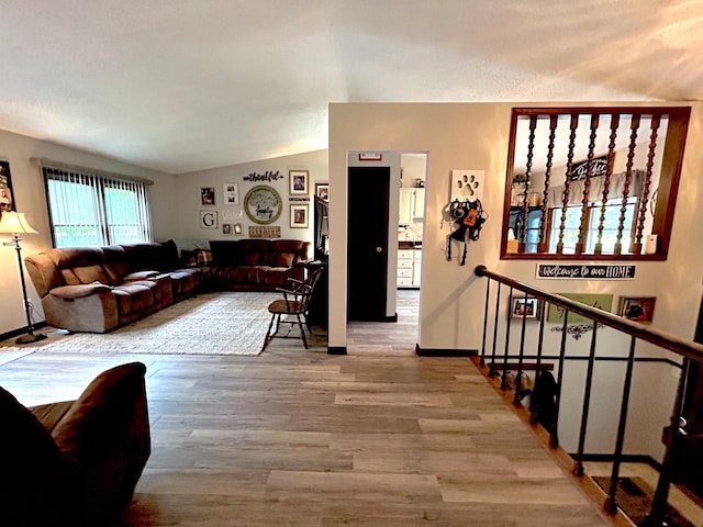 2621 Golf Course Rd, Wisconsin Rapids, WI 54494 - living room with wood finished floors, vaulted ceiling, and baseboards
