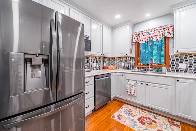 503 N 43rd Ave, Wausau, WI 54401 - kitchen with stainless steel appliances, a sink, white cabinets, light countertops, and recessed lighting