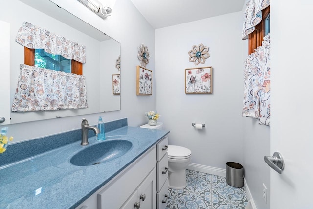 503 N 43rd Ave, Wausau, WI 54401 - bathroom with vanity, toilet, tile patterned flooring, and baseboards