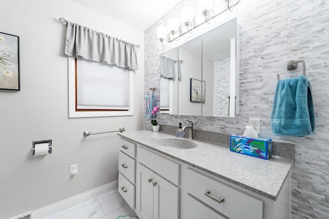 503 N 43rd Ave, Wausau, WI 54401 - bathroom with vanity, baseboards, and marble look tiles