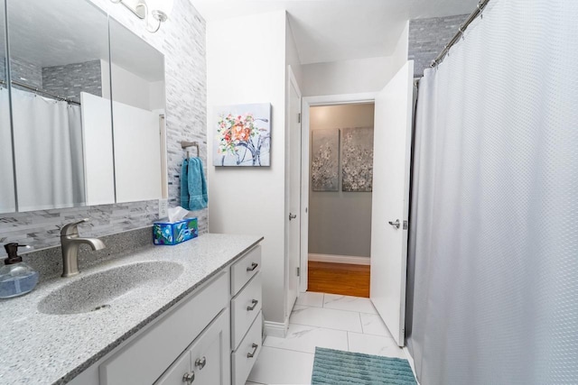 503 N 43rd Ave, Wausau, WI 54401 - full bath featuring marble finish floors, vanity, baseboards, and curtained shower