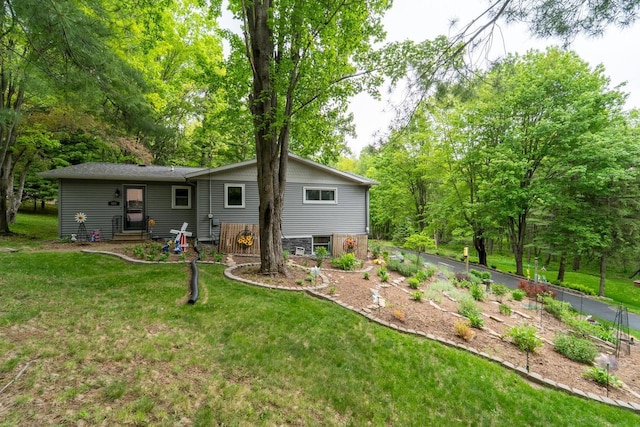 503 N 43rd Ave, Wausau, WI 54401 - rear view of house with a lawn, entry steps, and a garden