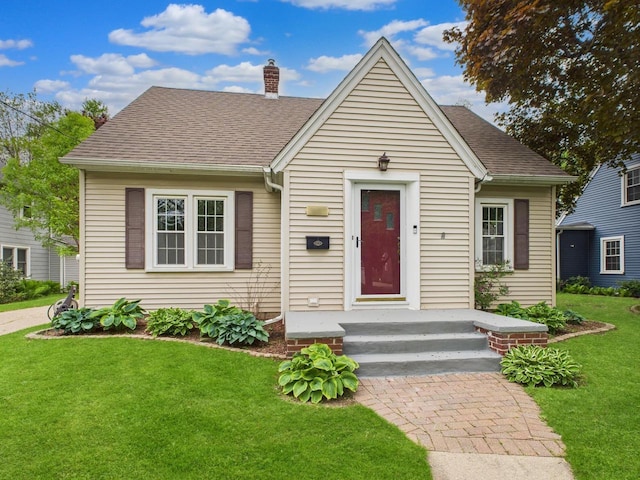1607 N Erb St, Appleton, WI 54911 - view of front of home with a chimney, a front lawn, and roof with shingles