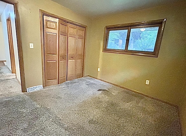 5404 N Bethmaur Ln, Milwaukee, WI 53209 - unfurnished bedroom featuring carpet flooring, a closet, and baseboards