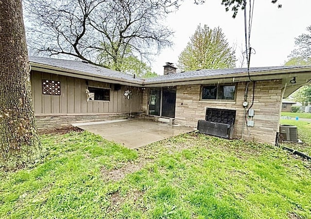 5404 N Bethmaur Ln, Milwaukee, WI 53209 - rear view of house featuring a chimney, a patio area, central AC unit, a yard, and board and batten siding