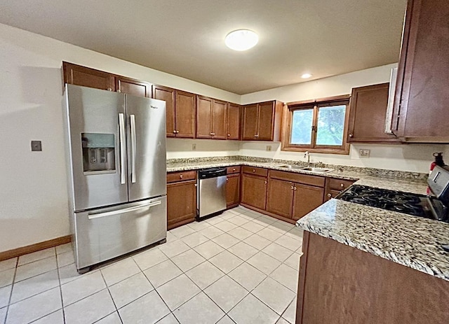 5404 N Bethmaur Ln, Milwaukee, WI 53209 - kitchen featuring appliances with stainless steel finishes, a sink, light tile patterned floors, and baseboards