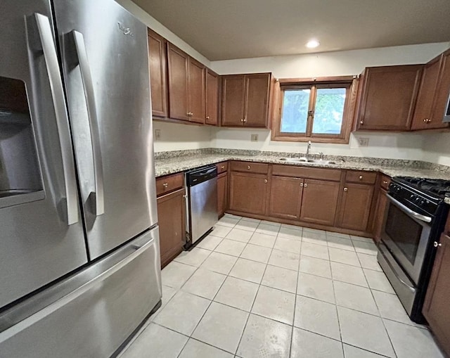 5404 N Bethmaur Ln, Milwaukee, WI 53209 - kitchen with appliances with stainless steel finishes, a sink, light tile patterned flooring, light stone counters, and recessed lighting