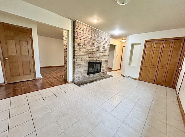 5404 N Bethmaur Ln, Milwaukee, WI 53209 - unfurnished living room with a fireplace, light tile patterned floors, and baseboards