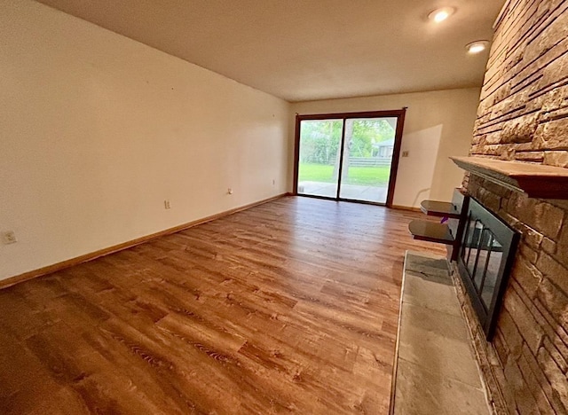 5404 N Bethmaur Ln, Milwaukee, WI 53209 - unfurnished living room with a fireplace, wood finished floors, and baseboards