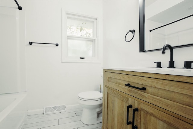 85 N Reserve Ave, Fond Du Lac, WI 54935 - bathroom with vanity, toilet, baseboards, bathtub / shower combination, and wood finished floors