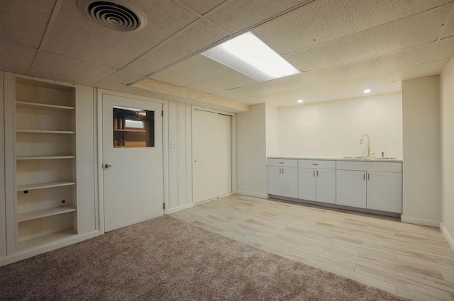 85 N Reserve Ave, Fond Du Lac, WI 54935 - interior space with a sink, a drop ceiling, built in features, baseboards, and light carpet