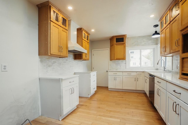 85 N Reserve Ave, Fond Du Lac, WI 54935 - kitchen featuring wall chimney range hood, dishwasher, a sink, decorative backsplash, and light wood-style flooring