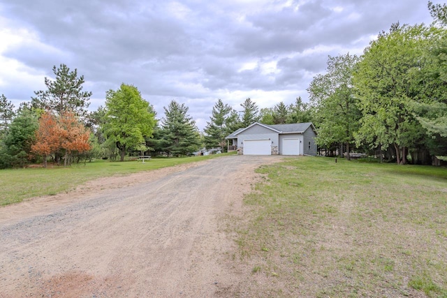5304 Ski Ln, Weston, WI 54476 - view of front facade with a front lawn, driveway, an outdoor structure, and view of wooded area