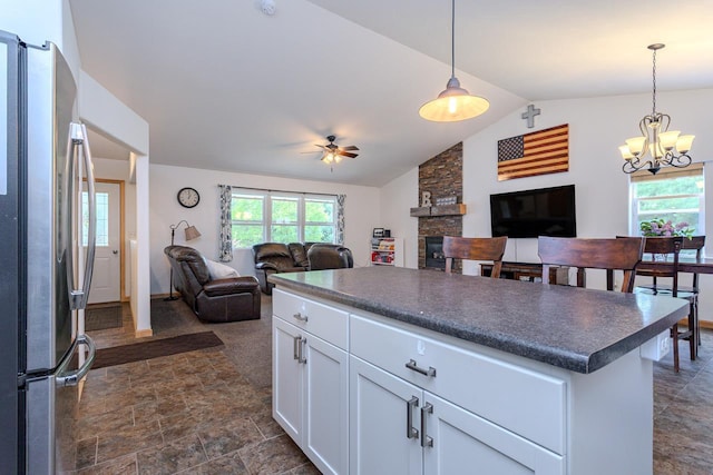 5304 Ski Ln, Weston, WI 54476 - kitchen with freestanding refrigerator, open floor plan, dark countertops, a ceiling fan, and vaulted ceiling