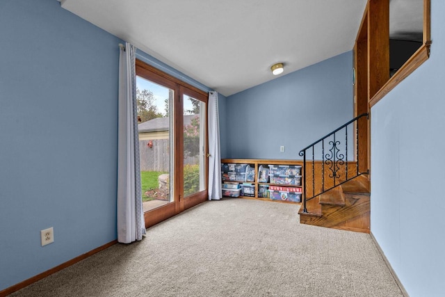 768 Reed St, Neenah, WI 54956 - carpeted empty room featuring baseboards and stairway