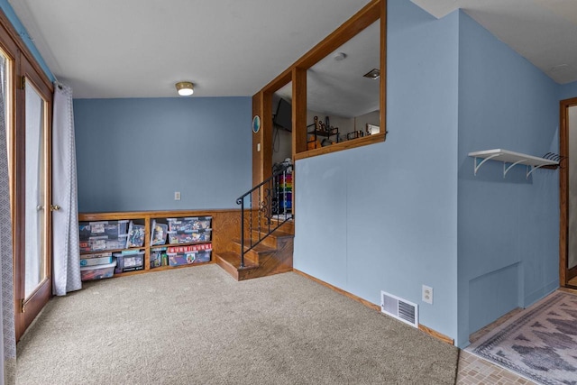 768 Reed St, Neenah, WI 54956 - spare room featuring stairway and carpet