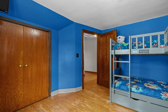 768 Reed St, Neenah, WI 54956 - bedroom with wood finished floors, baseboards, a closet, and vaulted ceiling