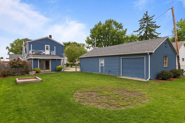 768 Reed St, Neenah, WI 54956 - back of property with a chimney, a detached garage, and a balcony