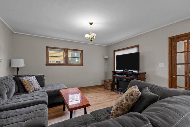 768 Reed St, Neenah, WI 54956 - living area featuring wood finished floors, crown molding, and a chandelier