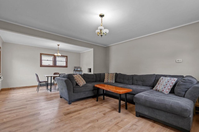 768 Reed St, Neenah, WI 54956 - living area featuring a chandelier, light wood-type flooring, baseboards, and crown molding