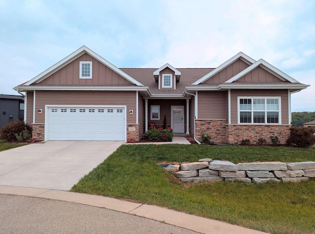 5829 Prairie Cloud Ct, Waunakee, WI 53597 - craftsman inspired home with stone siding, board and batten siding, a front lawn, and concrete driveway