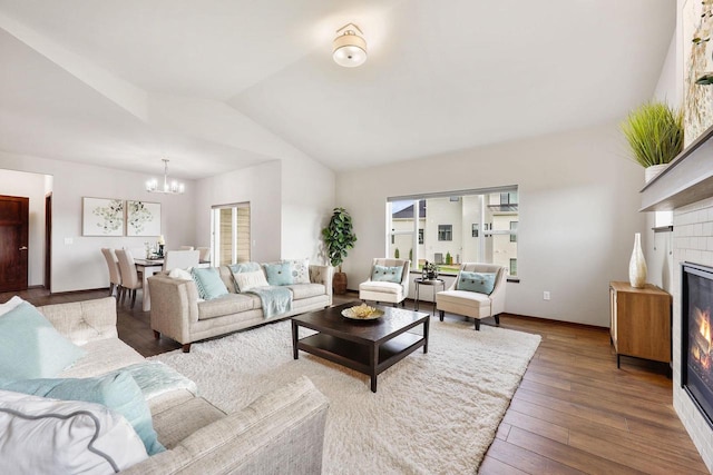 5829 Prairie Cloud Ct, Waunakee, WI 53597 - living room with a chandelier, a tiled fireplace, lofted ceiling, hardwood / wood-style floors, and healthy amount of natural light