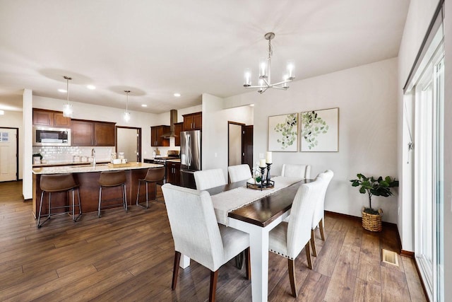 5829 Prairie Cloud Ct, Waunakee, WI 53597 - dining room with dark wood-type flooring, a chandelier, and recessed lighting