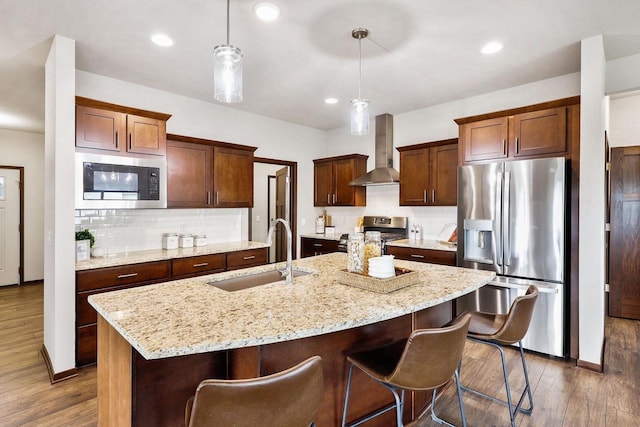 5829 Prairie Cloud Ct, Waunakee, WI 53597 - kitchen featuring appliances with stainless steel finishes, wall chimney exhaust hood, dark wood-type flooring, tasteful backsplash, and recessed lighting