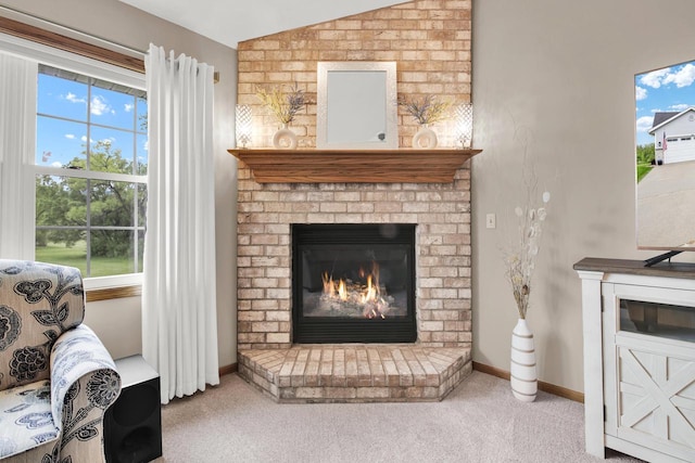 6905 Jamestown Ct, West Bend, WI 53090 - carpeted living room with a brick fireplace, vaulted ceiling, and baseboards
