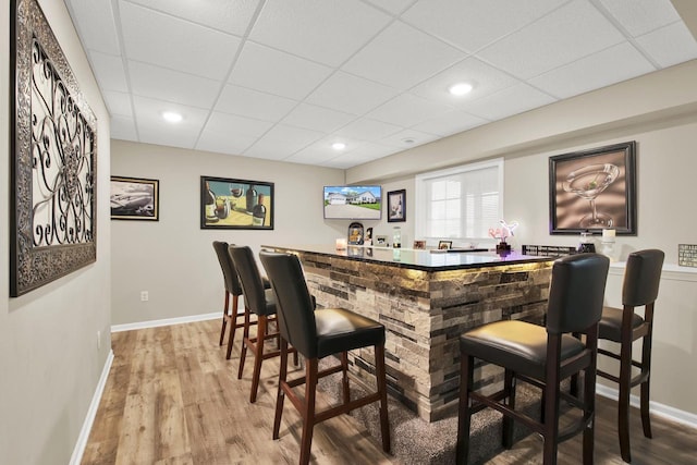 6905 Jamestown Ct, West Bend, WI 53090 - indoor dry bar featuring baseboards, a drop ceiling, wood finished floors, and recessed lighting