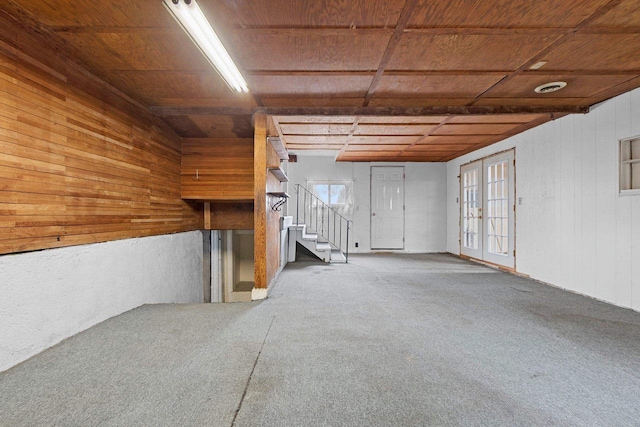 314 Summit St, Pulaski, WI 54162 - below grade area with wood walls, stairway, carpet floors, wooden ceiling, and french doors