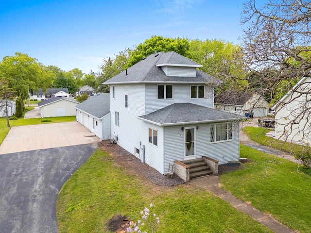 314 Summit St, Pulaski, WI 54162 - view of front facade with roof with shingles, a front yard, and a detached garage