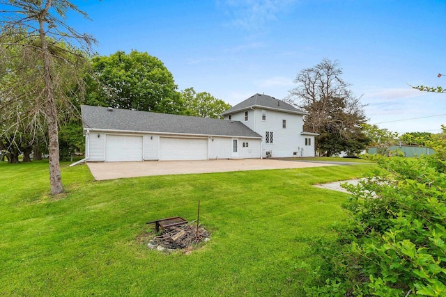 314 Summit St, Pulaski, WI 54162 - back of property featuring a lawn, a garage, and driveway