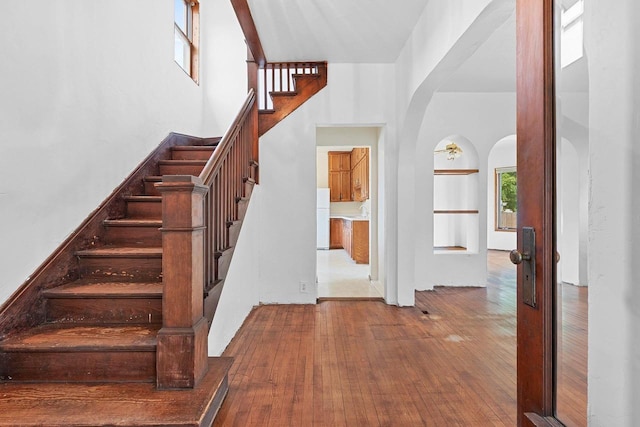 314 Summit St, Pulaski, WI 54162 - stairway with arched walkways and hardwood / wood-style floors