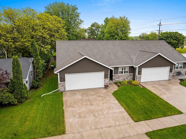 1302 Daytona Ln, Little Chute, WI 54140 - view of front of property featuring stone siding, roof with shingles, concrete driveway, and board and batten siding