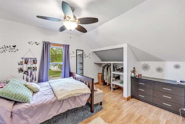 127 Flora St, Pulaski, WI 54162 - bedroom featuring light wood-type flooring, vaulted ceiling, a walk in closet, a closet, and ceiling fan