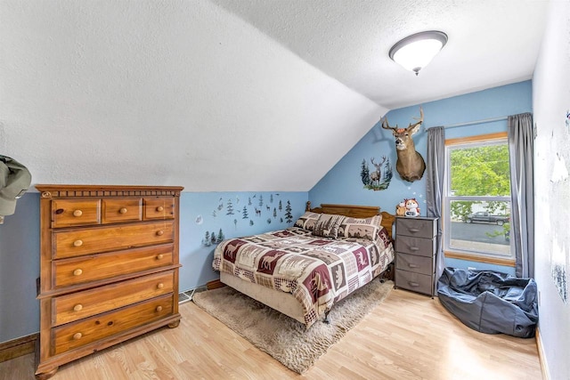 127 Flora St, Pulaski, WI 54162 - bedroom with light wood-style flooring, a textured ceiling, and vaulted ceiling