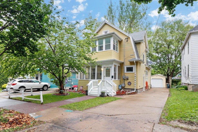 2314 Sommers Ave, Madison, WI 53704 - view of front of house featuring a gambrel roof, an outdoor structure, a detached garage, and a front lawn