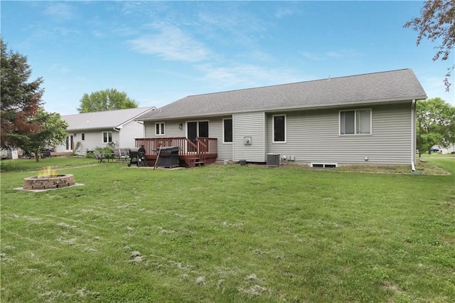 2531 Balsam Ct, Eau Claire, WI 54703 - back of house with a fire pit, a wooden deck, a lawn, and central air condition unit