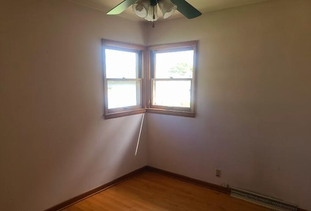 3602 N 85th St Unit 3604, Milwaukee, WI 53222 - spare room with a baseboard radiator, a ceiling fan, baseboards, and light wood-type flooring