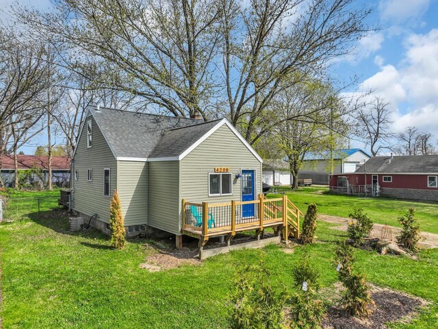 4208 Locust St, Delavan, WI 53115 - back of property with a wooden deck, roof with shingles, and central AC unit