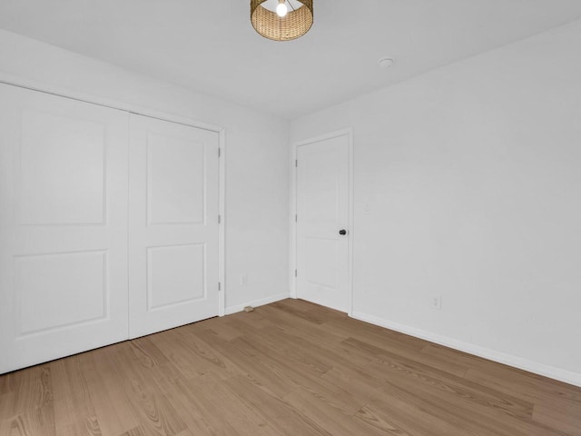 4208 Locust St, Delavan, WI 53115 - unfurnished bedroom with light wood-style flooring, baseboards, and a closet
