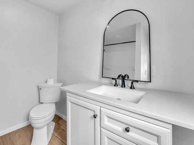 4208 Locust St, Delavan, WI 53115 - bathroom featuring vanity, toilet, wood finished floors, and baseboards
