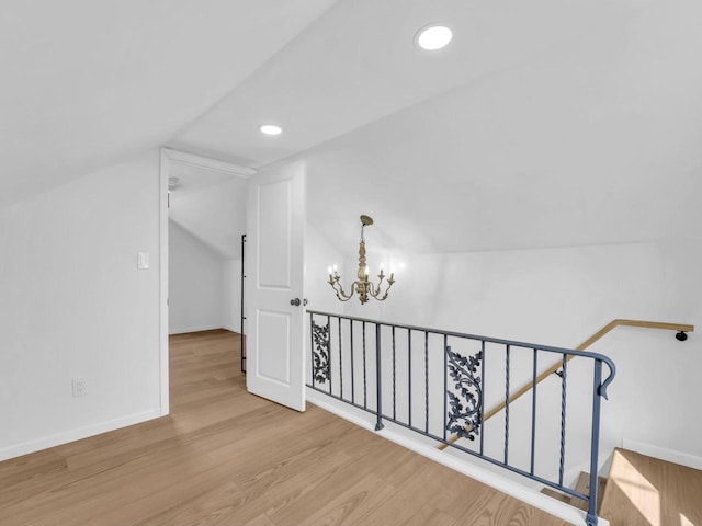 4208 Locust St, Delavan, WI 53115 - bonus room featuring a chandelier, vaulted ceiling, wood finished floors, recessed lighting, and baseboards